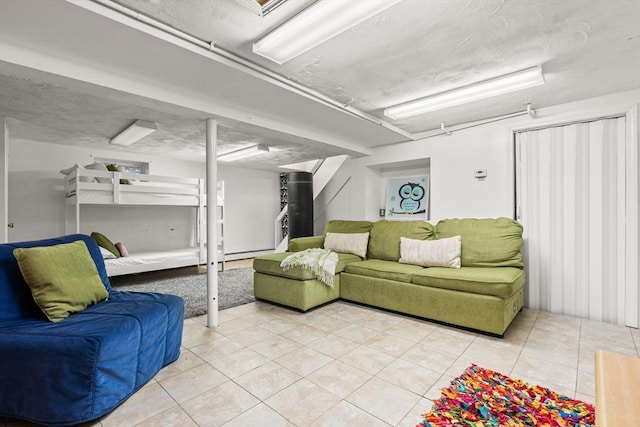 15 University Rd, Arlington, MA 02474 - living area featuring light tile patterned floors and a baseboard heating unit
