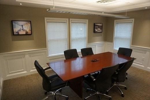 office with carpet floors, visible vents, and wainscoting