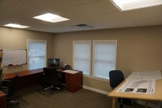 office area featuring a paneled ceiling, baseboards, and visible vents