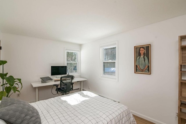 bedroom featuring wood finished floors and baseboards