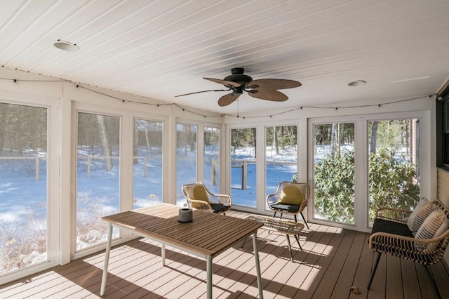 unfurnished sunroom featuring ceiling fan