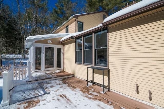 view of snowy exterior featuring a wooden deck