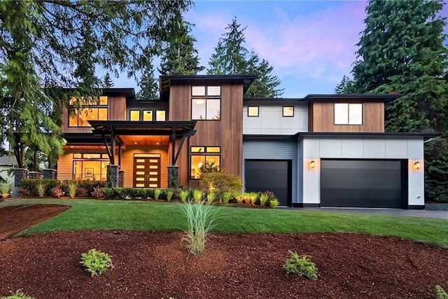 modern home featuring a yard and a garage