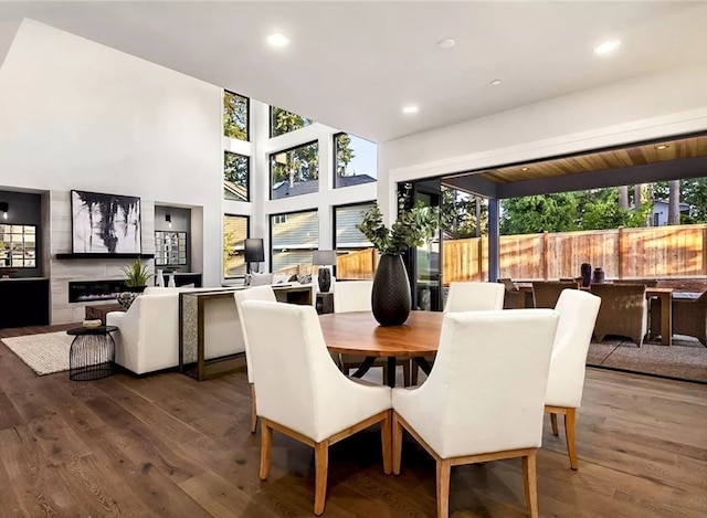 dining space featuring a fireplace and wood-type flooring