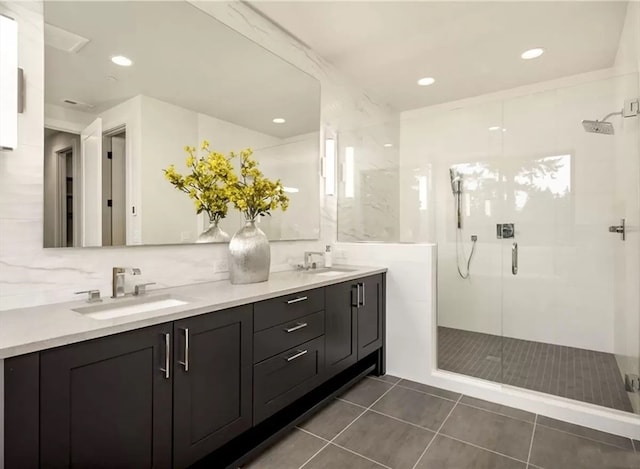 bathroom with tile patterned floors, vanity, and a shower with shower door