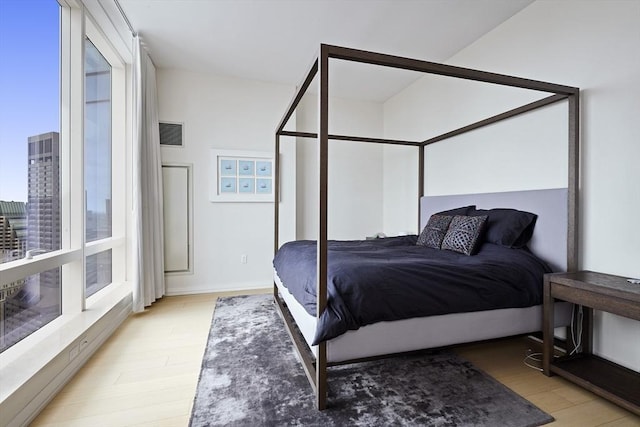 bedroom with visible vents and light wood-style flooring