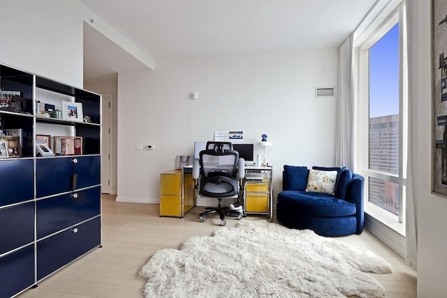 home office with visible vents and wood finished floors