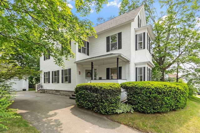 20 Walden St, Lowell, MA 01851 - view of front of property featuring an outdoor structure, a shingled roof, and a porch