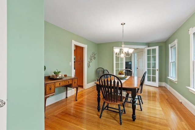 20 Walden St, Lowell, MA 01851 - dining area with light wood-type flooring, a chandelier, and baseboards