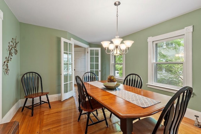 20 Walden St, Lowell, MA 01851 - dining space featuring a chandelier, light wood finished floors, and baseboards