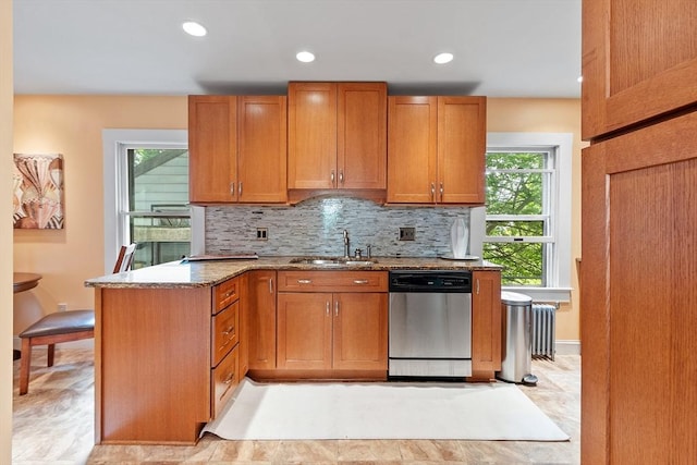 20 Walden St, Lowell, MA 01851 - kitchen with stainless steel dishwasher, a sink, light stone counters, decorative backsplash, and recessed lighting