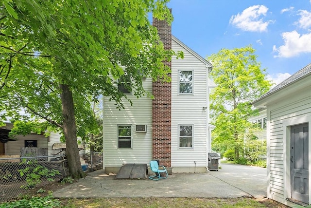 20 Walden St, Lowell, MA 01851 - back of house with a patio area and a chimney