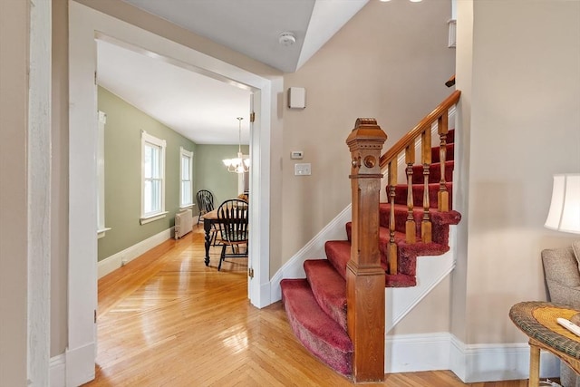 20 Walden St, Lowell, MA 01851 - stairs featuring a chandelier, radiator, baseboards, and wood finished floors