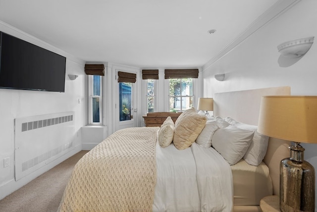 bedroom featuring light colored carpet, radiator, and crown molding