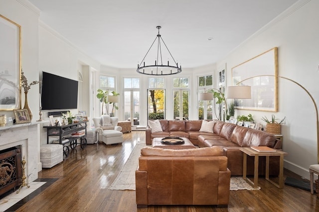 living room with french doors, a fireplace, dark hardwood / wood-style floors, and ornamental molding