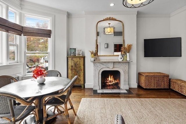 dining space with dark hardwood / wood-style flooring and crown molding