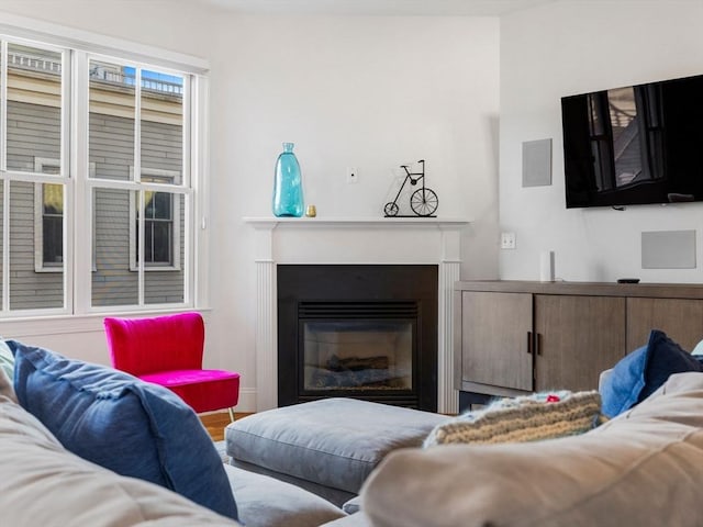 living room featuring a glass covered fireplace