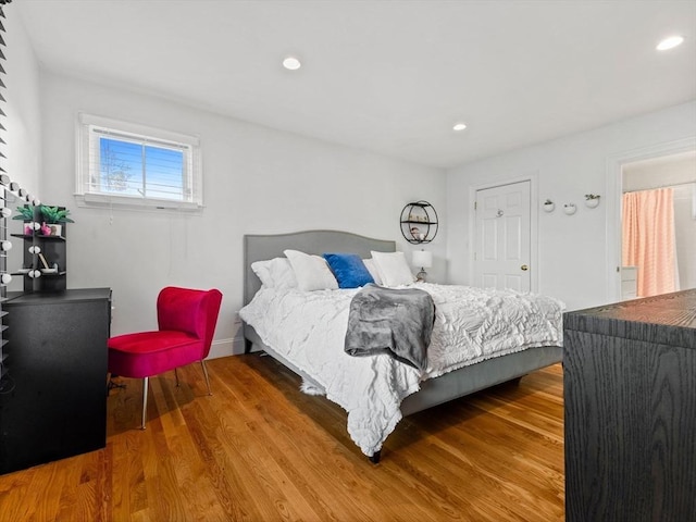 bedroom with recessed lighting and wood finished floors