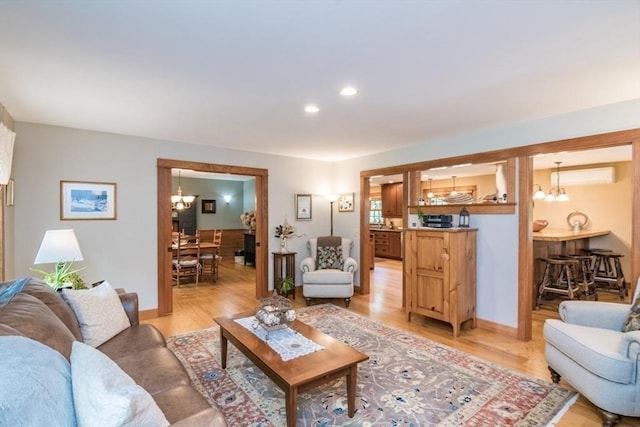 137 French King Hwy, Gill, MA 01354 - living room featuring a chandelier, a wall mounted AC, light wood finished floors, recessed lighting, and baseboards