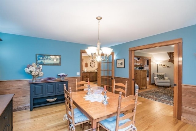 137 French King Hwy, Gill, MA 01354 - dining area with light wood-type flooring, a chandelier, and a wainscoted wall