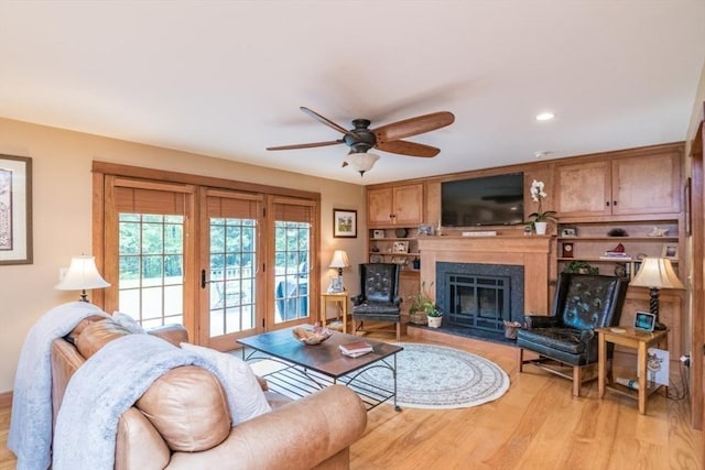 137 French King Hwy, Gill, MA 01354 - living area featuring light wood-style flooring, a ceiling fan, and a glass covered fireplace