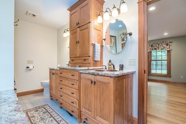 137 French King Hwy, Gill, MA 01354 - full bath with double vanity, toilet, and baseboards