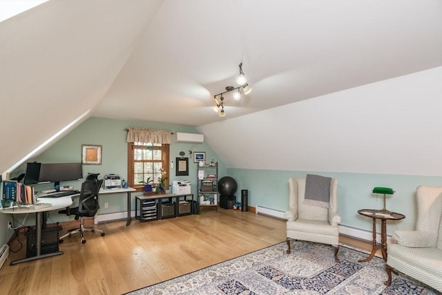 137 French King Hwy, Gill, MA 01354 - office with a baseboard radiator, an AC wall unit, wood finished floors, and vaulted ceiling