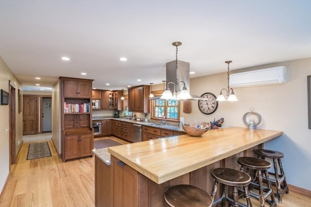 137 French King Hwy, Gill, MA 01354 - kitchen with stainless steel appliances, a peninsula, a wall unit AC, light wood-style floors, and glass insert cabinets