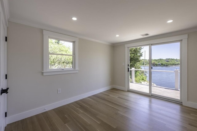 7 Cove Way, Gloucester, MA 01930 - spare room featuring wood finished floors, baseboards, crown molding, a water view, and recessed lighting