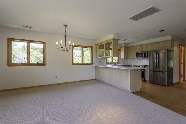 7 Cove Way, Gloucester, MA 01930 - kitchen featuring stainless steel appliances, a peninsula, plenty of natural light, and light countertops