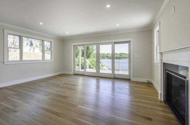 7 Cove Way, Gloucester, MA 01930 - unfurnished living room with wood finished floors, ornamental molding, baseboards, a glass covered fireplace, and recessed lighting