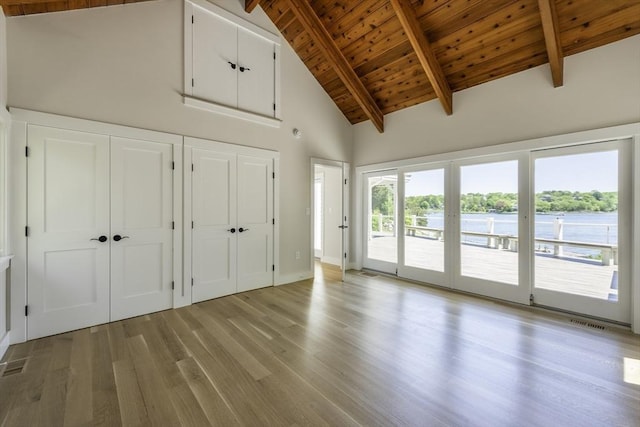 7 Cove Way, Gloucester, MA 01930 - unfurnished bedroom with access to outside, wooden ceiling with exposed beams, light wood-style flooring, high vaulted ceiling, and two closets