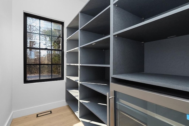 spacious closet featuring light wood-style flooring