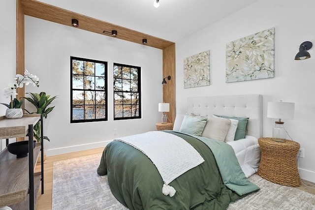 bedroom with baseboards and light wood-style floors