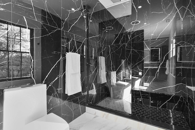 full bath featuring toilet and a stall shower