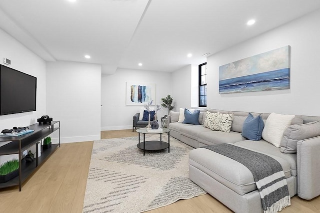 living area with recessed lighting, wood finished floors, and baseboards