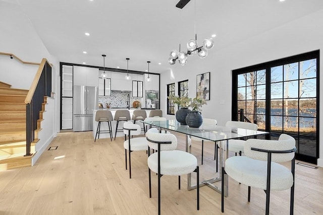 dining area featuring stairway, light wood-type flooring, and recessed lighting