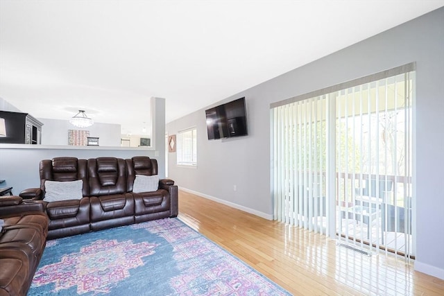 living area with wood finished floors and baseboards