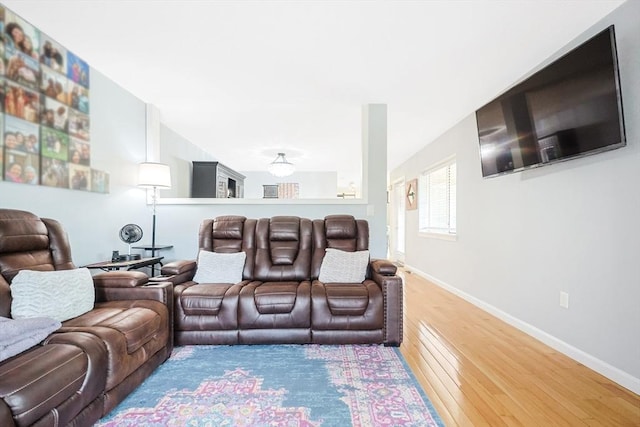 living area featuring baseboards and wood finished floors