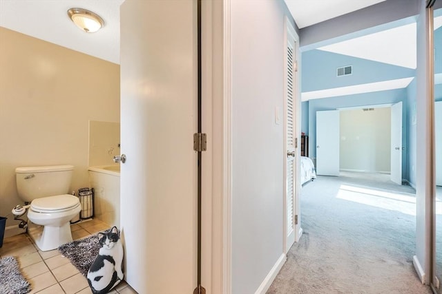 full bathroom with a washtub, visible vents, tile patterned floors, and toilet