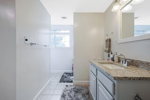 bathroom with tile patterned flooring, baseboards, vanity, and visible vents