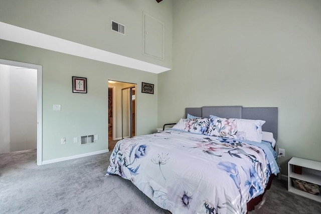 carpeted bedroom featuring baseboards, a towering ceiling, and visible vents