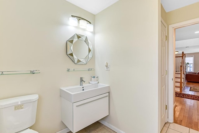 bathroom with tile patterned floors, toilet, and vanity