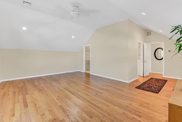 unfurnished living room with ceiling fan, lofted ceiling, and light hardwood / wood-style floors