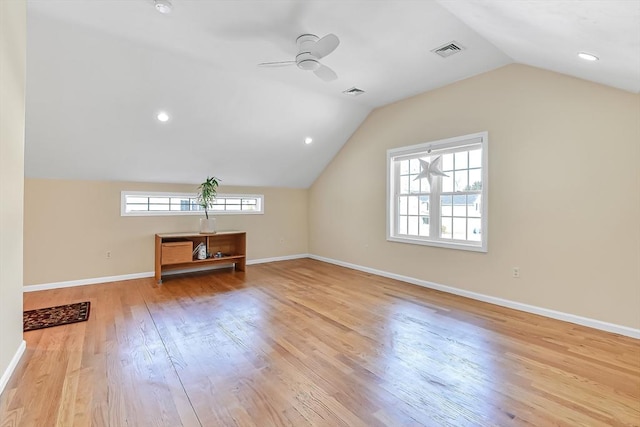 additional living space with lofted ceiling, light hardwood / wood-style flooring, and ceiling fan