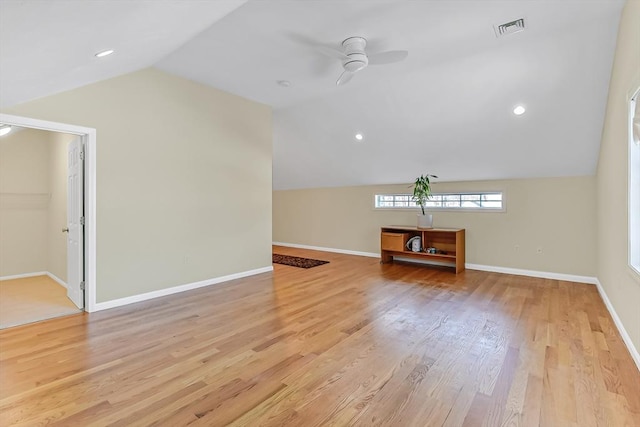 unfurnished living room featuring vaulted ceiling, ceiling fan, and light wood-type flooring