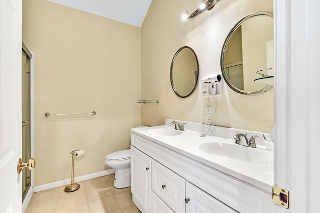 bathroom with tile patterned flooring, vanity, and toilet