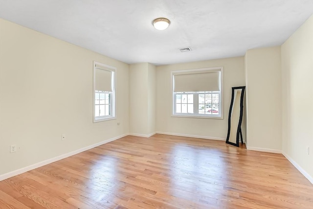 spare room featuring light wood-type flooring