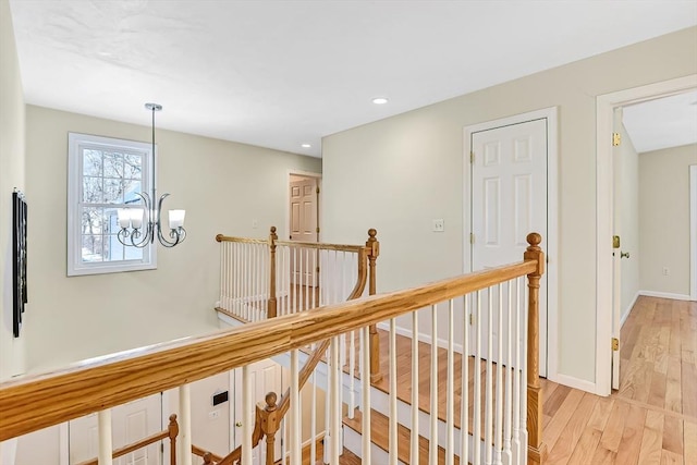 corridor featuring a notable chandelier and light hardwood / wood-style floors