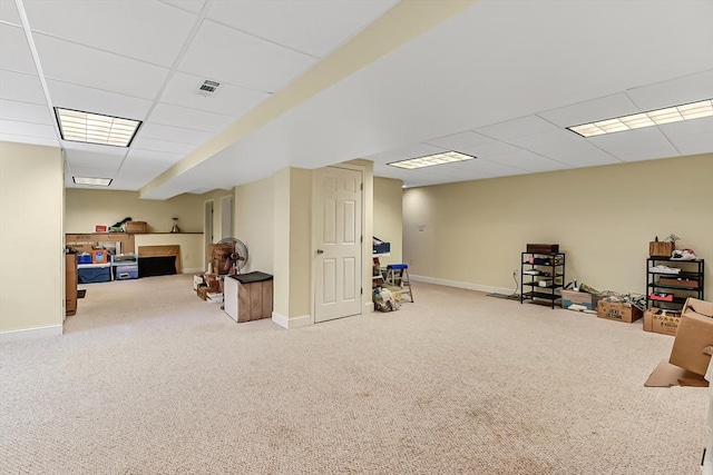 basement featuring carpet and a paneled ceiling